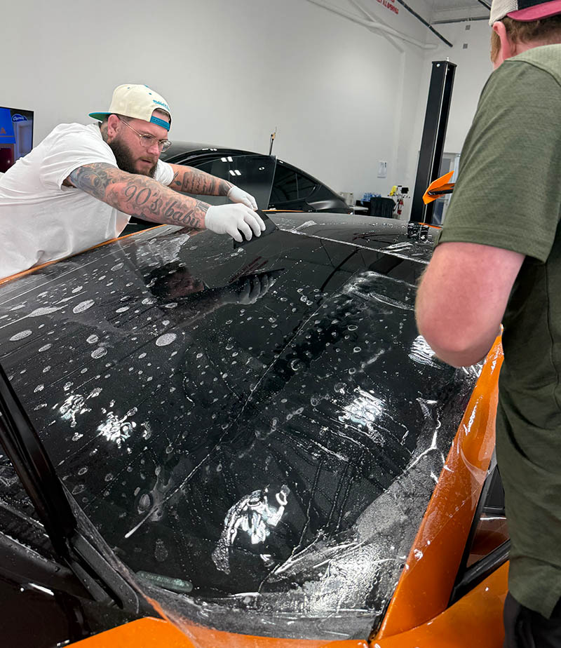 Staff installing film on Lamborghini at our fort myers shop